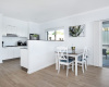 Kitchen vew and dining table with balcony door to the backyard