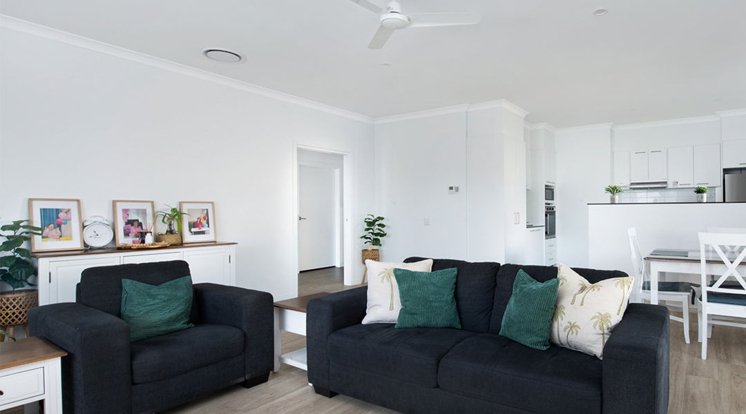 Living room view with kitchen in the background - Couches and open living