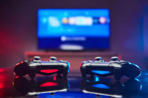 Two Video Game Controller in Front of a TV Screen